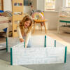 A child popping up the large hamster playpen.