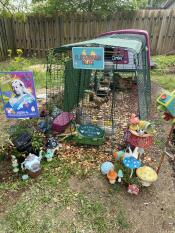 A beautifully decorated pink chicken coop with run