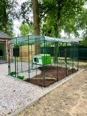 Eglu Cube Chicken Coop set up in Walk In Run with clear weather protection cover on roof.