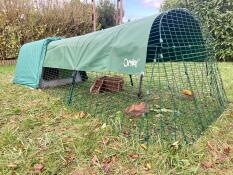 An opaque cover placed on a guinea pig run connected to a hutch