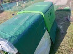 The Eglu Cube chicken coop run covered by a heavy duty cover.