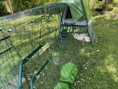 An Eglu Go Up chicken coop with handles.