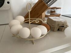 Selection of white and brown eggs on cream Egg Skelter display by Omlet.