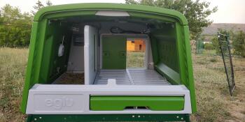 the inside of a green cube large chicken coop