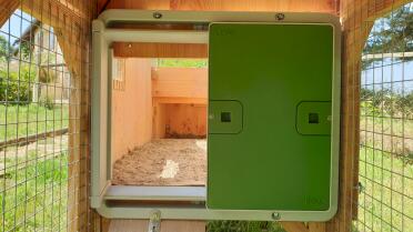 Automatic door installed on a wooden coop