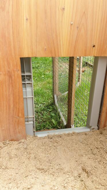 Automatic door installed on a wooden coop